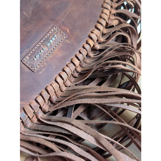 Brown leather sedona tassle bag in saddle brown with fringe, braided detailing, and loyal west brand patch