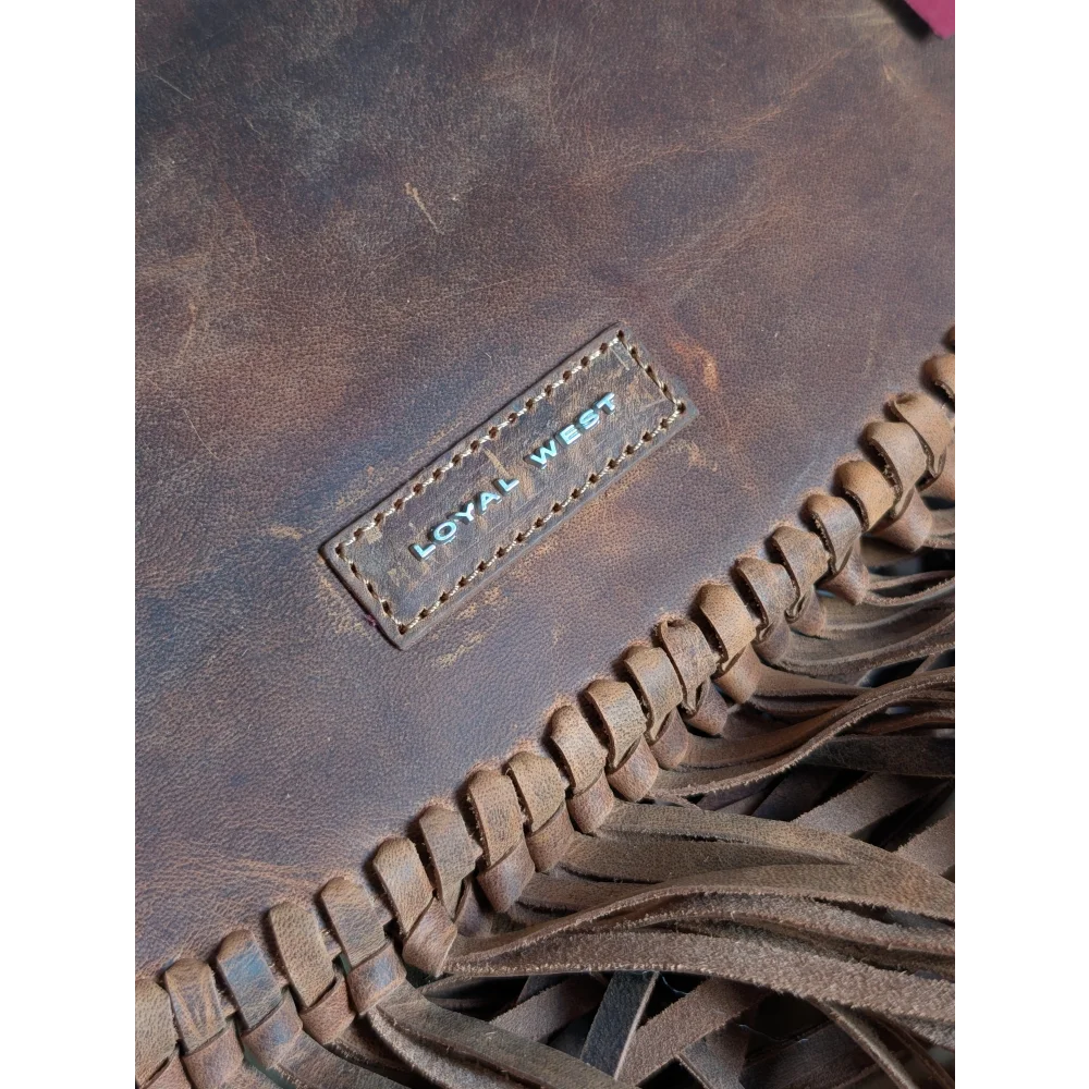 Brown leather sedona tassle bag with fringed detailing and loyal west brand patch in saddle brown