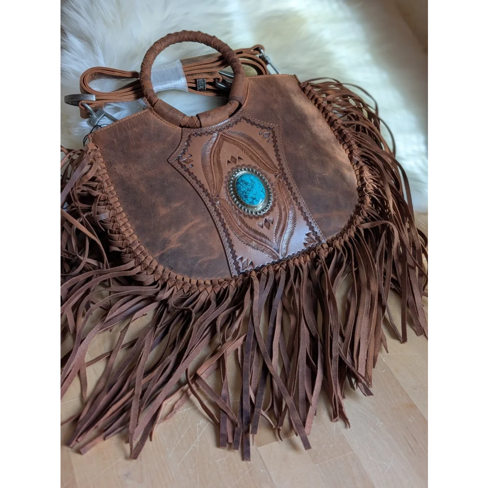 Brown leather sedona tassle bag with intricate tooled designs and turquoise stone in silver bezel in saddle brown