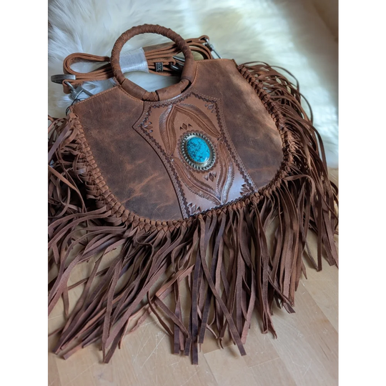 Brown leather sedona tassle bag with intricate tooled designs and turquoise stone in silver bezel in saddle brown