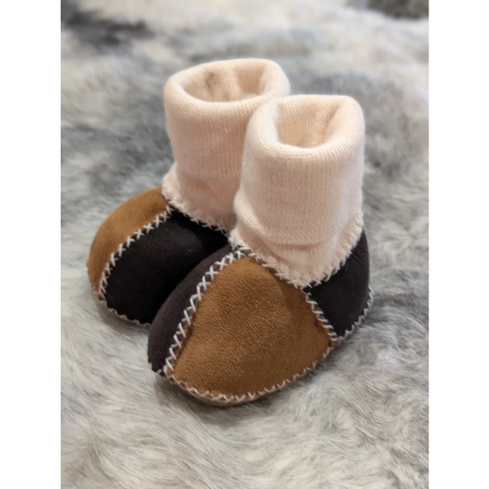 Fabulous sheepskin baby booties in two-tone brown and black with white stitching