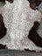 A plush tibet highland spotted sheepskin rug with a soft white and brown speckled pattern size 39x26 inches