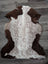 Brown and white tibet highland spotted sheepskin rug with natural fluffy texture perfect for cozy decor