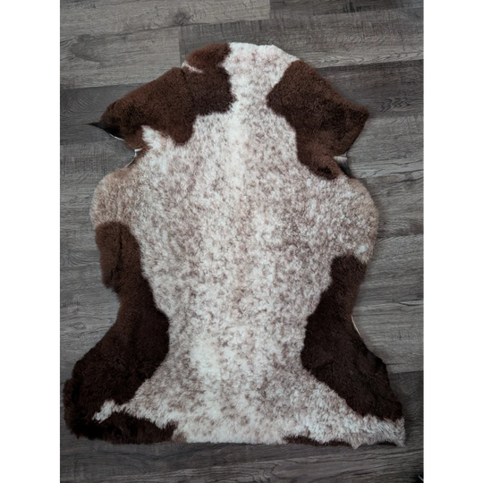Brown and white tibet highland spotted sheepskin rug with natural fluffy texture perfect for cozy decor