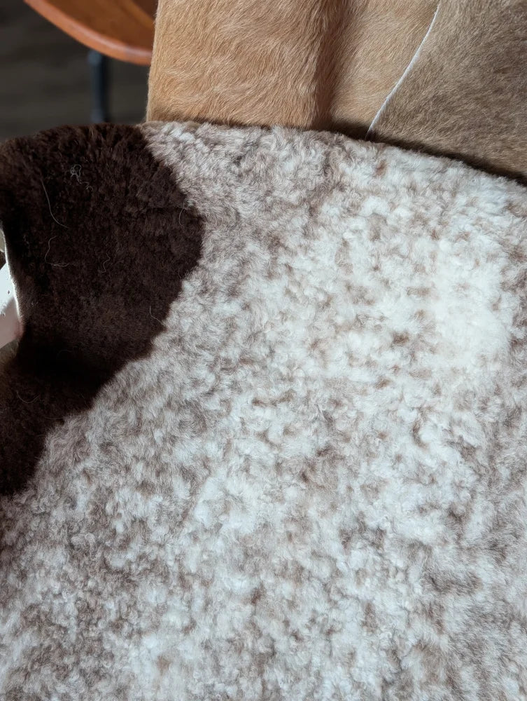 A cozy 39x26 inch tibet highland spotted sheepskin coat with soft white and brown fleece exterior grade a