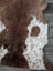 Brown and white tibet highland spotted sheepskin rug with a plush fluffy texture for cozy decor use