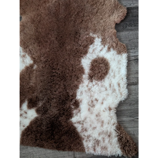 Brown and white tibet highland spotted sheepskin rug with a plush fluffy texture for cozy decor use