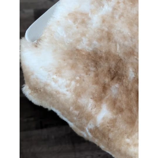 A plush cream and tan highland spotted sheepskin throw blanket with soft fluffy texture from tibet highland spotted grade a