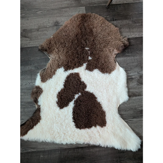 Brown and white fluffy tibet highland spotted sheepskin rug with natural texture for cozy home decor