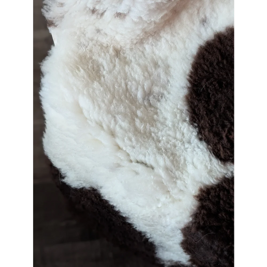 A gorgeous tibet highland spotted sheepskin rug in soft white and dark brown plush fur grade a quality