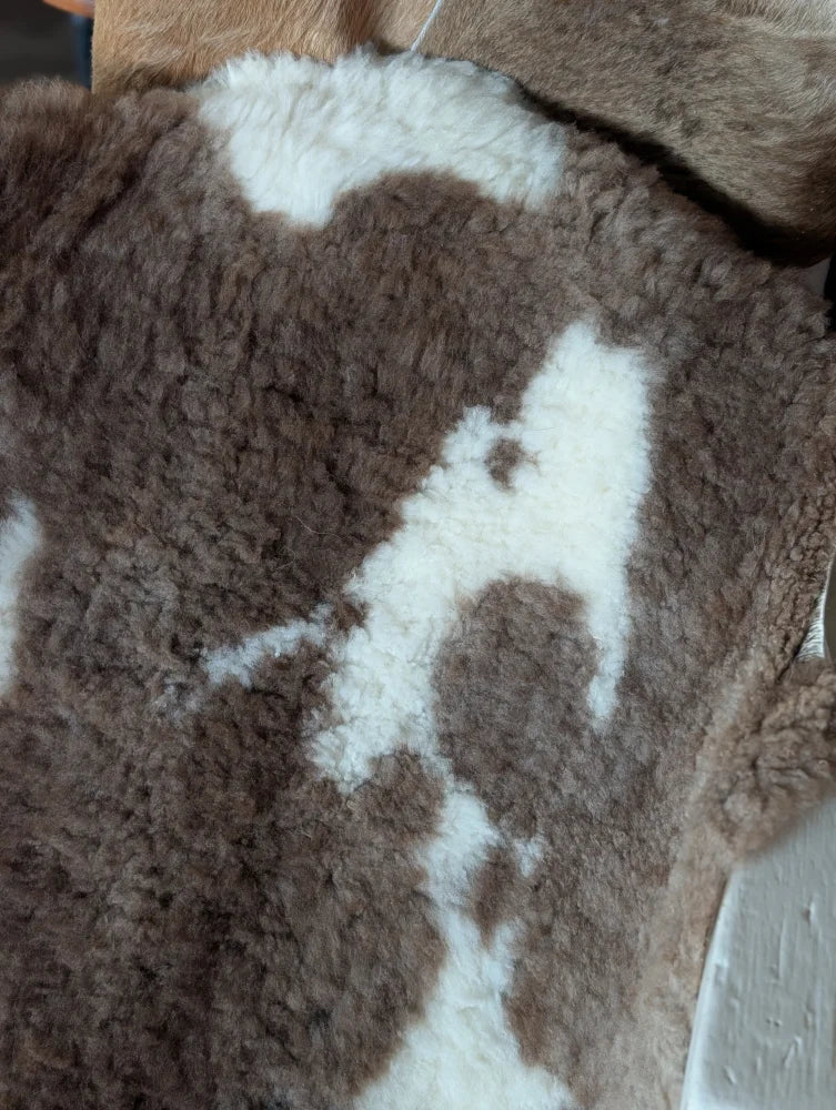 Brown and white tibet highland spotted sheepskin with plush textured surface perfect for cozy decor or rugs