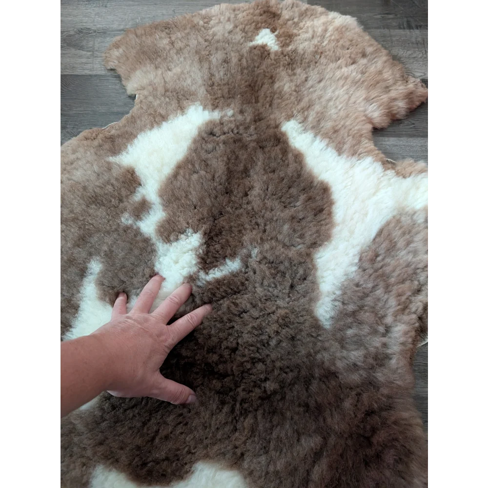 A plush highland spotted sheepskin rug with soft brown and white fur in tibet highland spotted style sh2 41.5 x 26