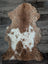 A soft brown and white tibet highland spotted sheepskin rug in plush grade a natural wool design