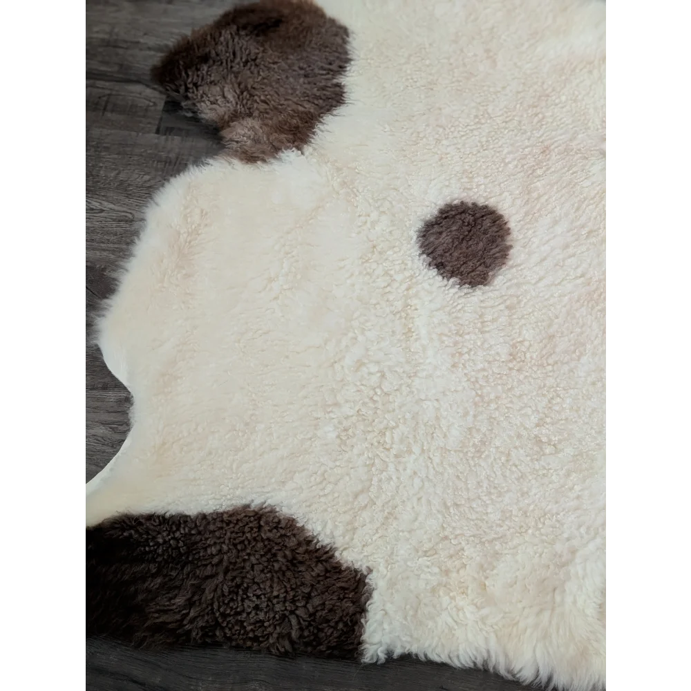 Cream-colored tibet highland spotted sheepskin rug with dark brown patches in 46 x 27 size for cozy decor