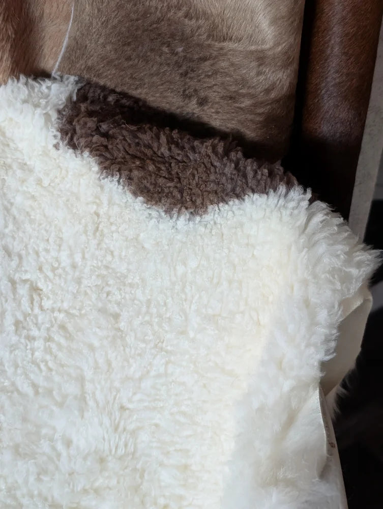 White fluffy sheepskin vest with brown fleece collar made from grade a tibet highland spotted sheepskin