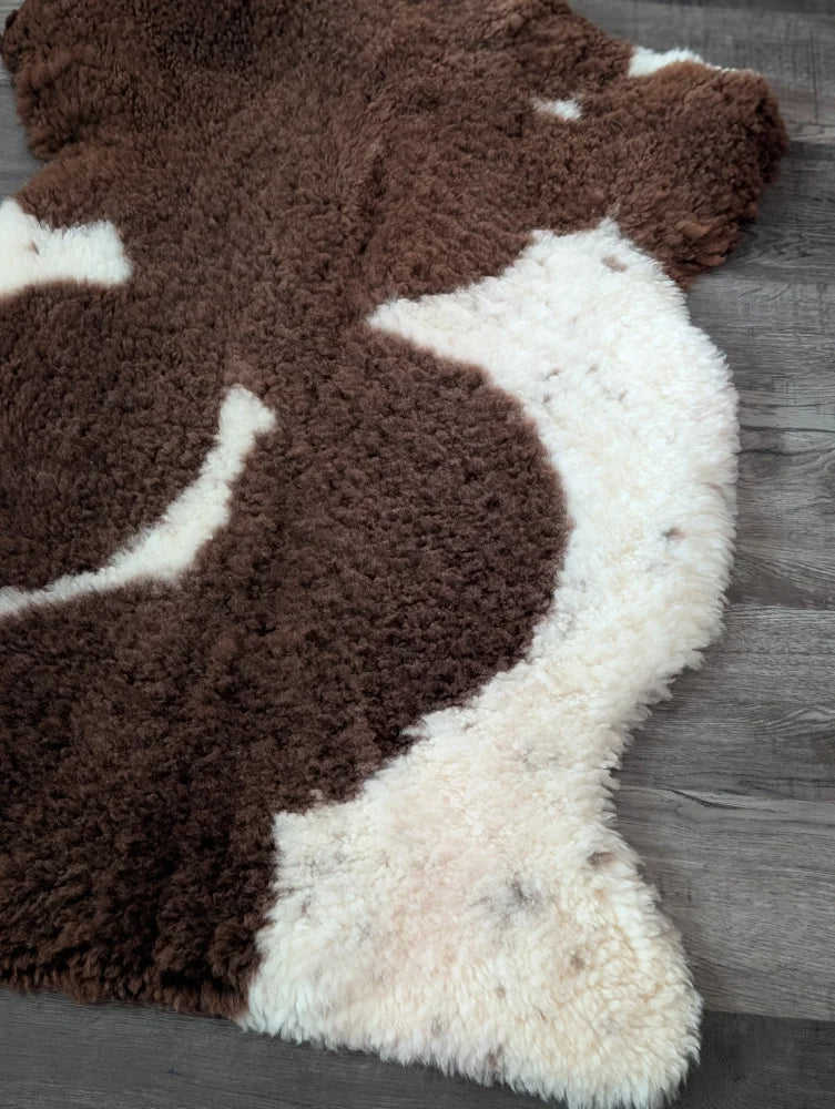 Brown and white highland spotted sheepskin rug 41 by 26 inches made from grade a tibet highland spotted wool