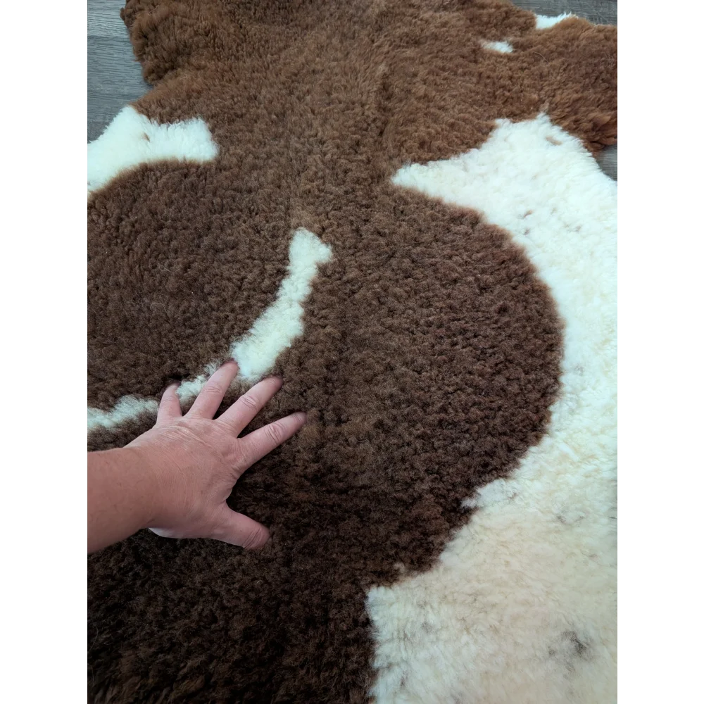 Brown and white tibet highland spotted sheepskin rug with a soft fluffy texture perfect for cozy decor