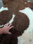 Brown and white tibet highland spotted sheepskin rug with a soft fluffy texture perfect for cozy decor