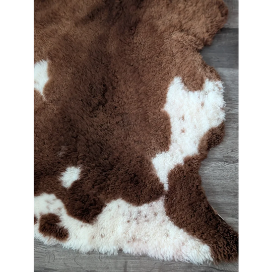 Brown and white tibet highland spotted sheepskin rug with soft plush faux fur texture 43 x 26 inches