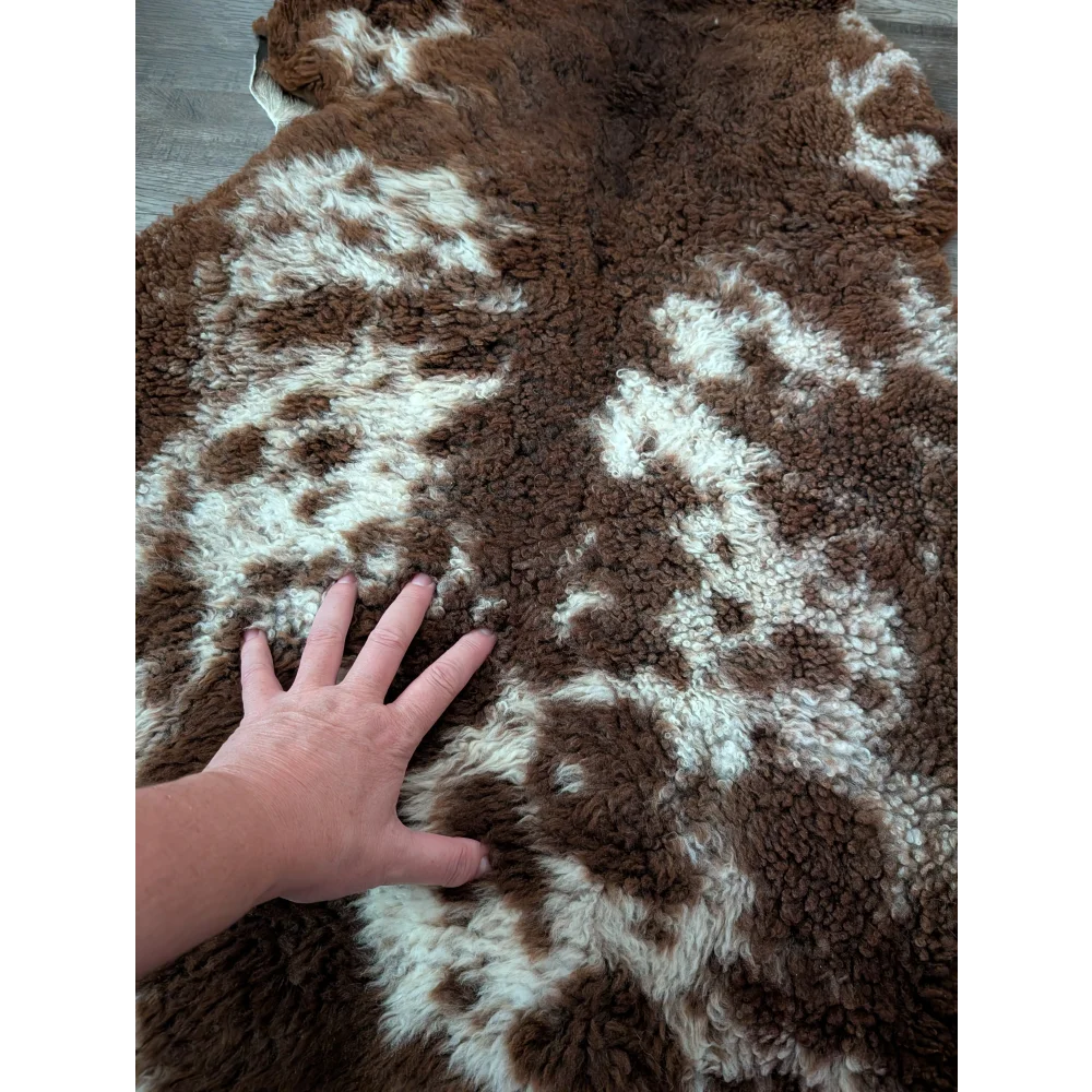 Brown and white plush tibet highland spotted sheepskin rug 41 by 25 inches with a soft fluffy texture