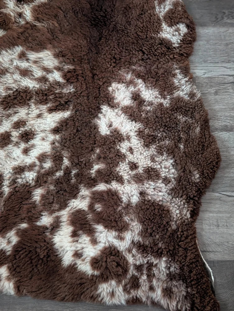 Brown and white tibet highland spotted sheepskin rug with plush soft texture ideal for cozy home decor
