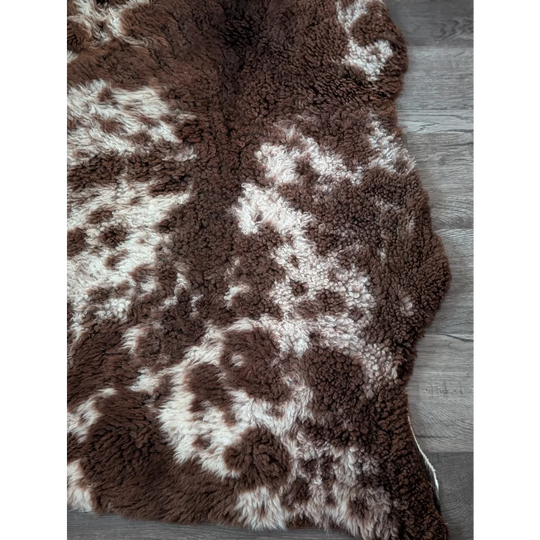 Brown and white tibet highland spotted sheepskin rug with plush soft texture ideal for cozy home decor
