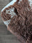 Brown and white fluffy fleece blanket made from grade a tibet highland spotted sheepskin with a soft textured surface