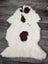 Fluffy white tibet highland spotted sheepskin rug with three dark brown patches in a vertical line 44 x 26 inches