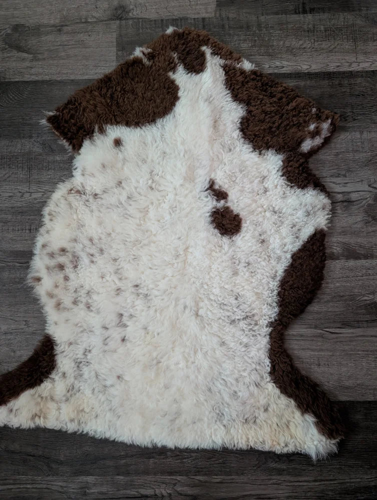 A gorgeous 39 x 25 inch tibet highland spotted sheepskin rug with natural white and brown spots in grade a quality