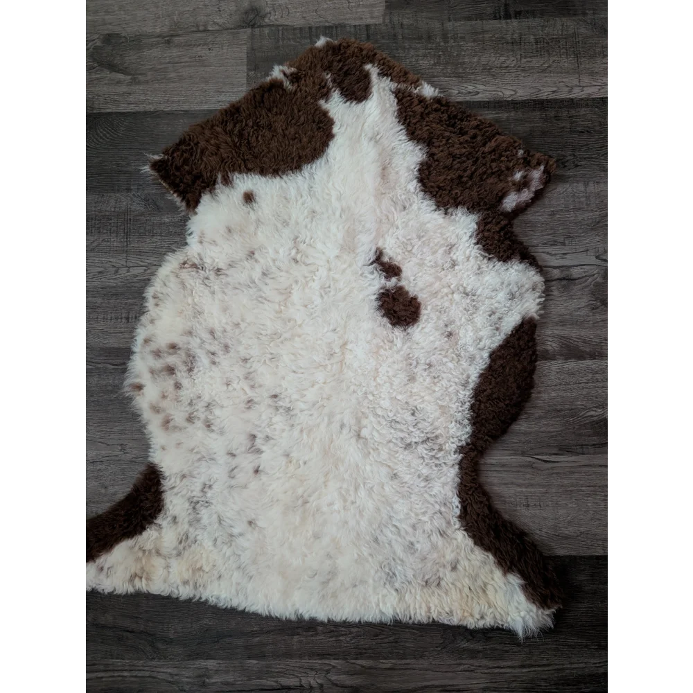 A gorgeous 39 x 25 inch tibet highland spotted sheepskin rug with natural white and brown spots in grade a quality
