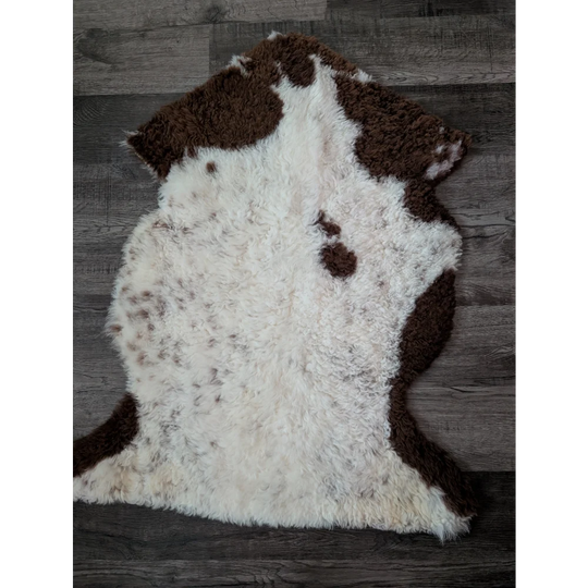 A gorgeous 39 x 25 inch tibet highland spotted sheepskin rug with natural white and brown spots in grade a quality