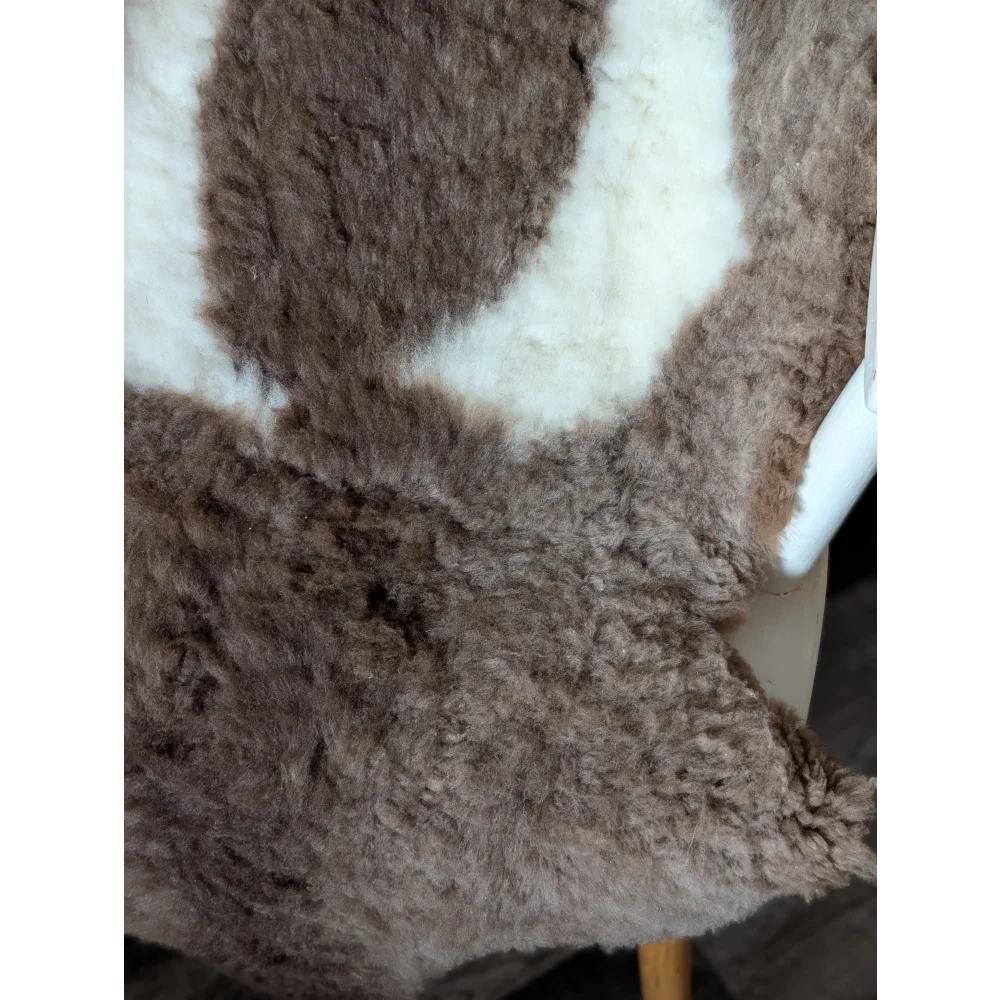 A gorgeous tibet highland spotted sheepskin rug in soft brown and creamy white plush grade a quality