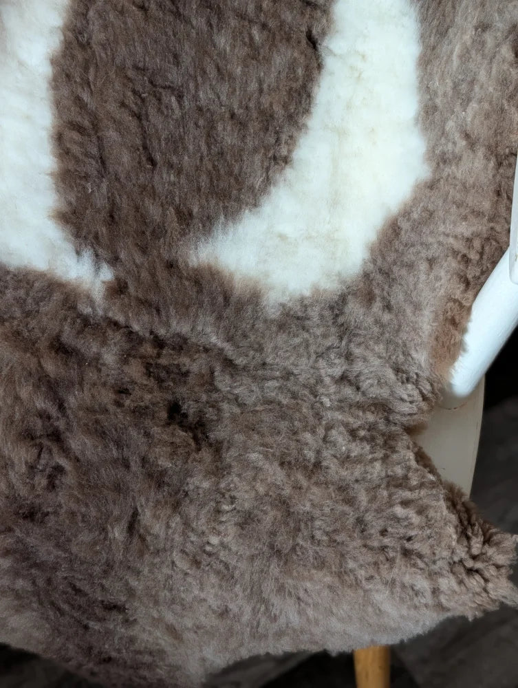 A gorgeous tibet highland spotted sheepskin rug in soft brown and creamy white plush grade a quality