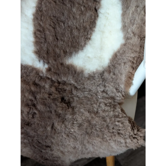 A gorgeous tibet highland spotted sheepskin rug in soft brown and creamy white plush grade a quality