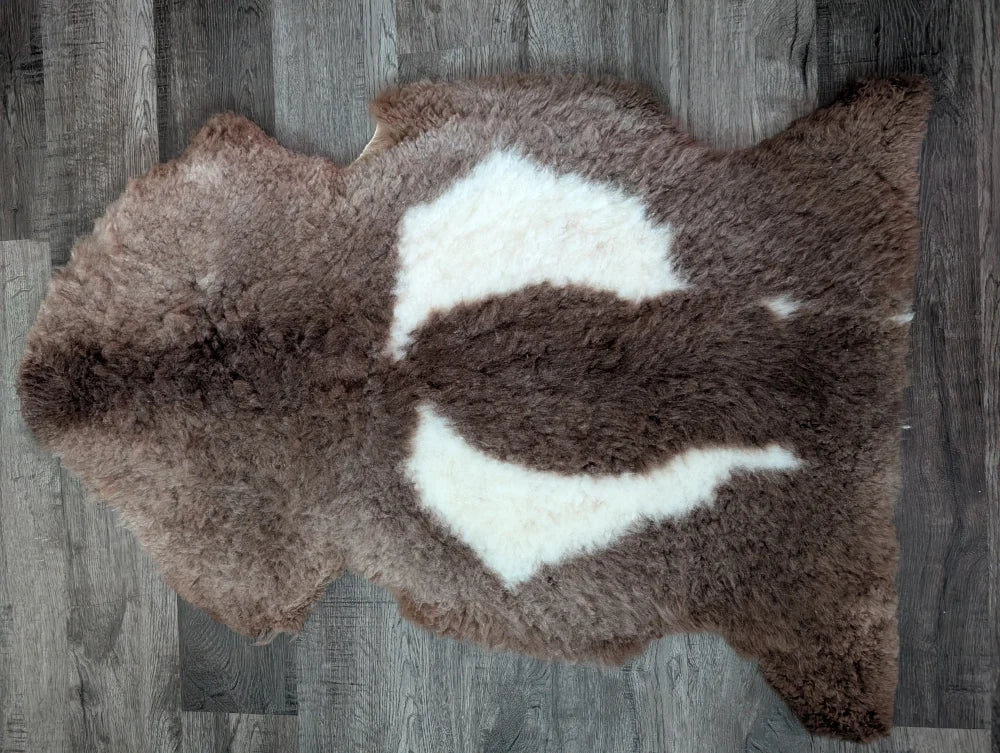 Brown and white tibet highland spotted sheepskin rug with natural fluffy texture 42 by 25.5 inches grade a quality