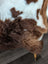 Brown and white cow print faux fur throw blanket made from grade a tibet highland spotted sheepskin measuring 42 x 25 inches