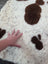 A plush white and brown tibet highland spotted sheepskin rug with a soft textured surface perfect for cozy spaces