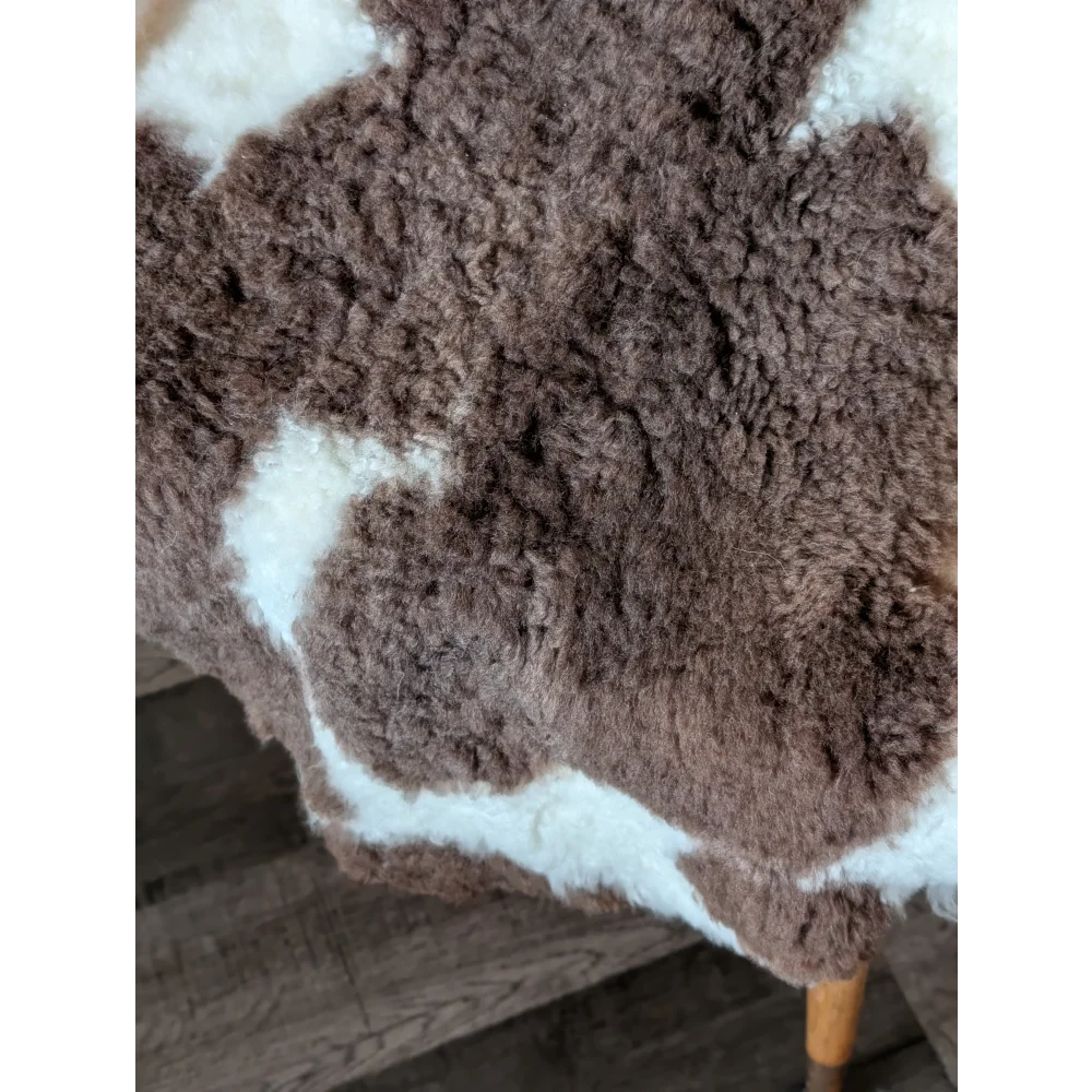 Brown and white tibet highland spotted sheepskin rug with natural fluffy texture perfect for cozy decor