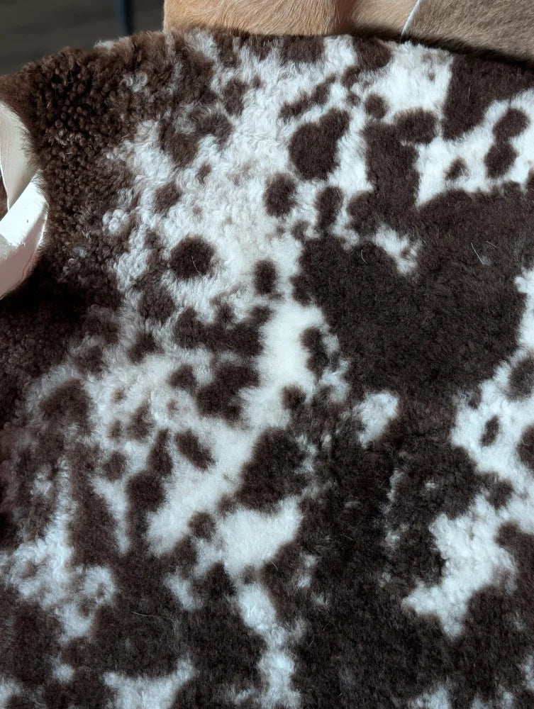 Brown and white speckled shearling vest made from tibet highland spotted grade a sheepskin for cozy warmth