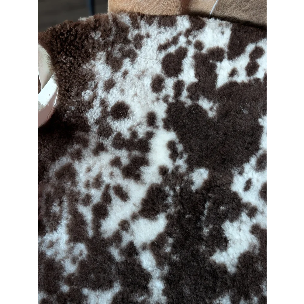 Brown and white speckled shearling vest made from tibet highland spotted grade a sheepskin for cozy warmth