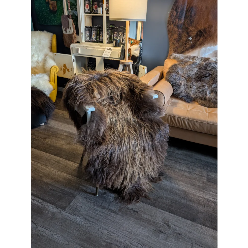 Thick shaggy long wool icelandic sheepskin throw in natural bronze draped over a chair for cozy decor