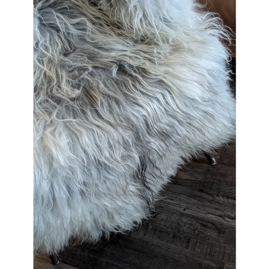 A plush long wool icelandic sheepskin rug in natural grey with soft texture measuring 55 x 35 inches