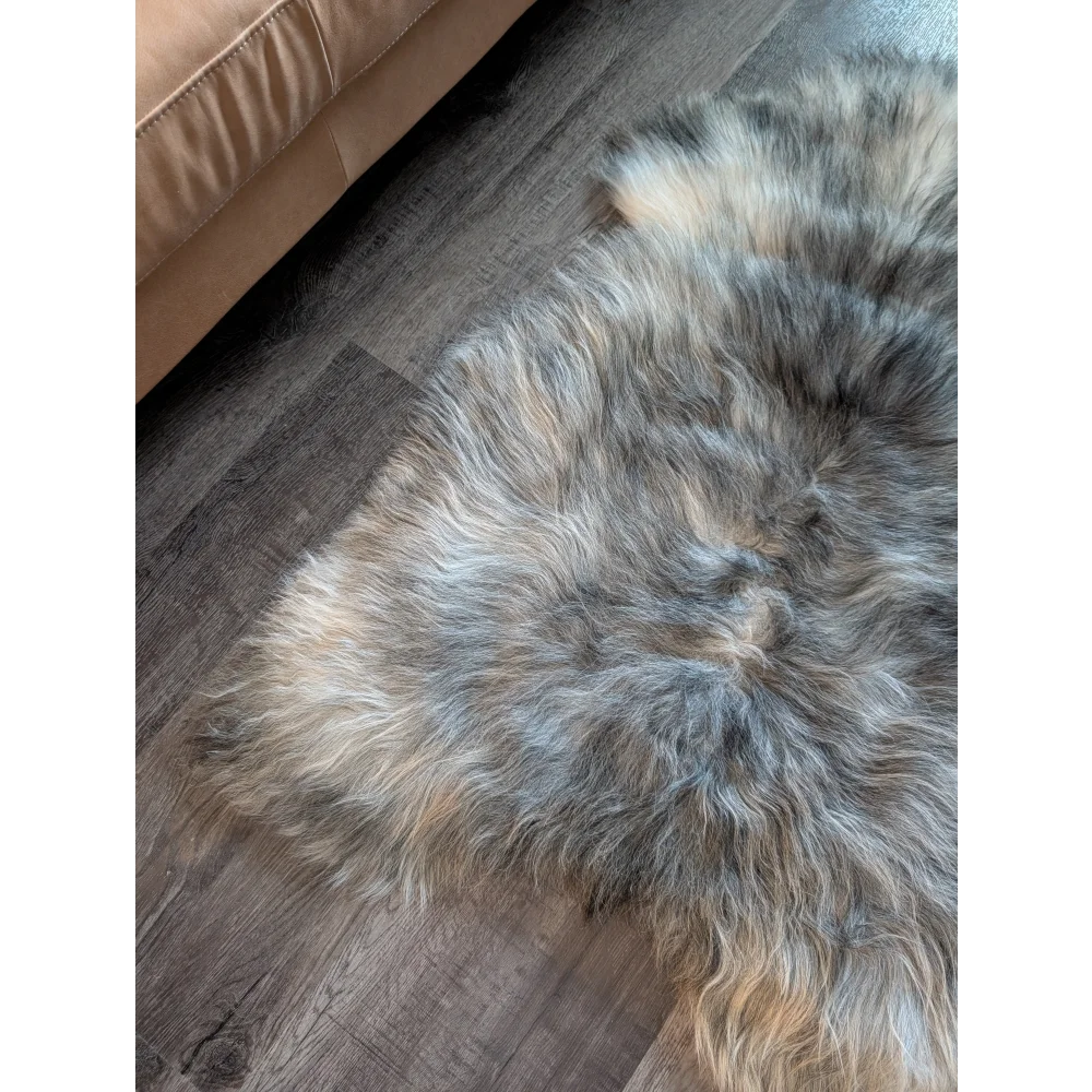 A massive icelandic sheepskin rug in natural grey with soft wool icelandic double texture in gray beige tones