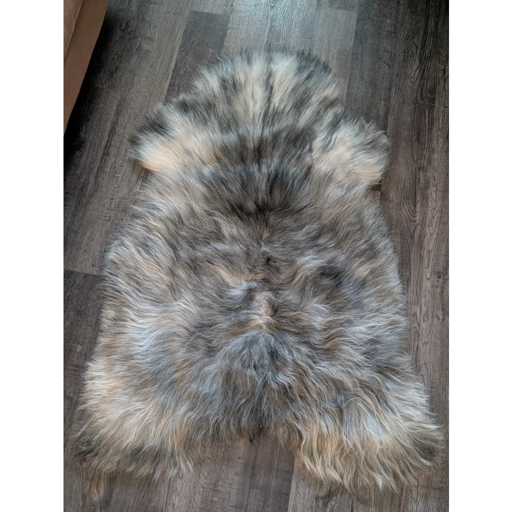 A massive 54 by 33 inch icelandic sheepskin rug with natural grey double icelandic wool and soft fluffy texture