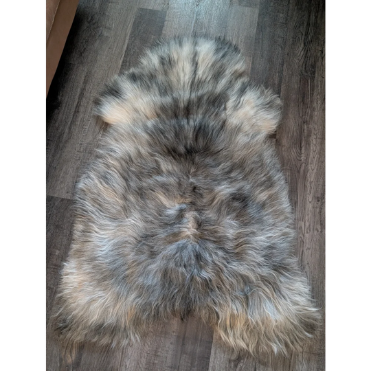 A massive 54 by 33 inch icelandic sheepskin rug with natural grey double icelandic wool and soft fluffy texture
