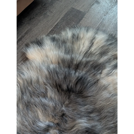 A plush massive 54 x 33 inch icelandic sheepskin rug in natural grey with soft wool icelandic texture and mixed hues