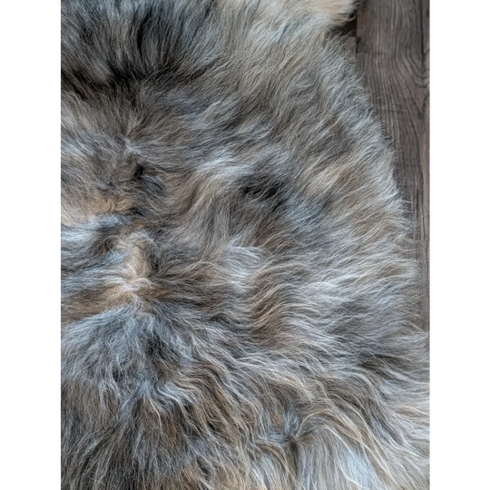 A plush gray and beige double icelandic sheepskin rug with natural wool texture and soft fluffy feel