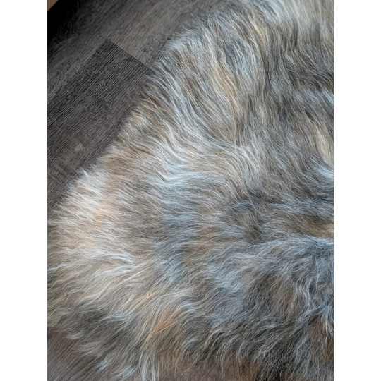 A plush multicolored wool icelandic faux fur rug in natural grey with soft shaggy texture 54 by 33 inches