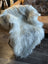 A plush white wool icelandic sheepskin throw draped over a chair in natural grey double icelandic style