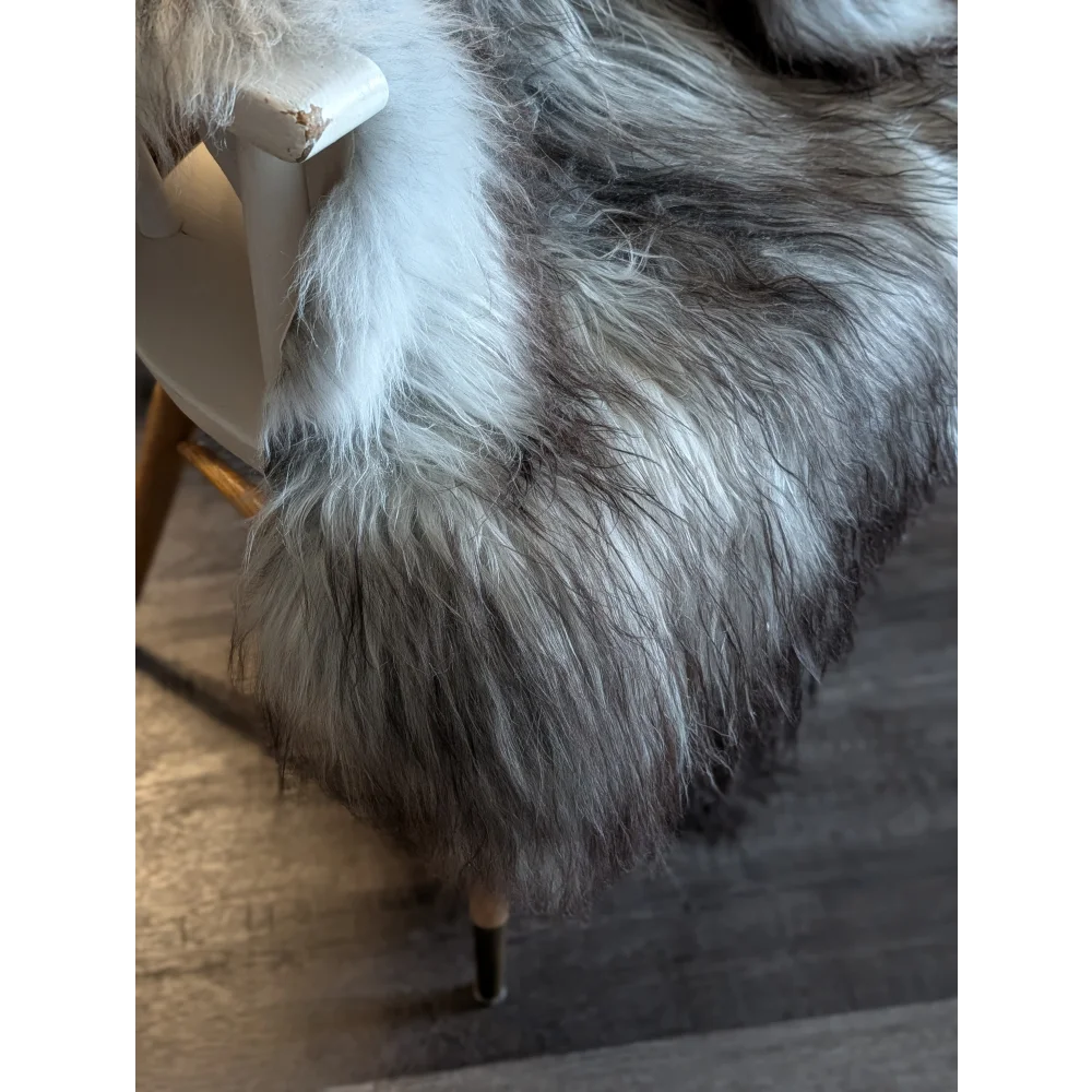 A plush icelandic sheepskin throw blanket in natural grey with soft double icelandic wool texture measuring 54 x 34 inches
